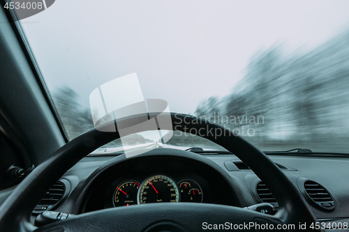 Image of Riding behind the wheel of a car in winter