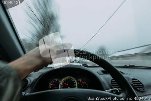Image of Riding behind the wheel of a car in winter