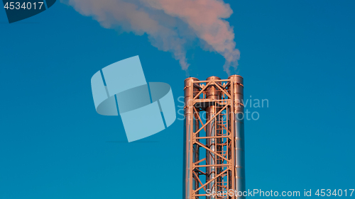 Image of shiny stainless steel metal pipe smokes