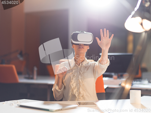 Image of businesswoman using VR-headset glasses of virtual reality