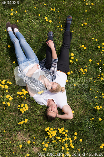 Image of man and woman lying on the grass