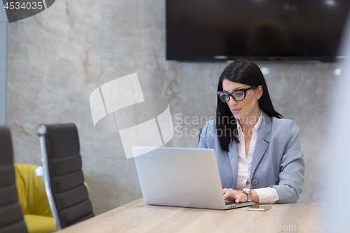 Image of businesswoman using a laptop in startup office