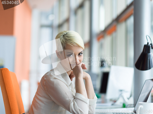 Image of businesswoman using a laptop in startup office