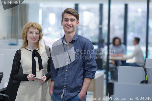 Image of Business People Working With Tablet in startup office