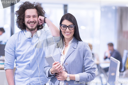 Image of Business People Working With Tablet in startup office