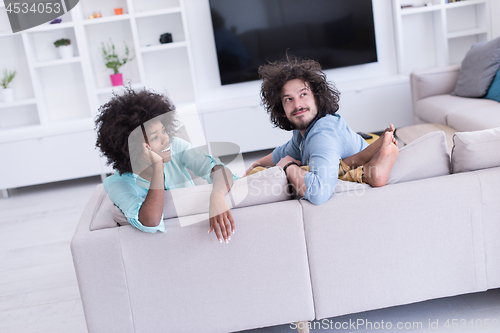 Image of young multiethnic couple in living room