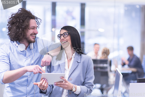 Image of Business People Working With Tablet in startup office