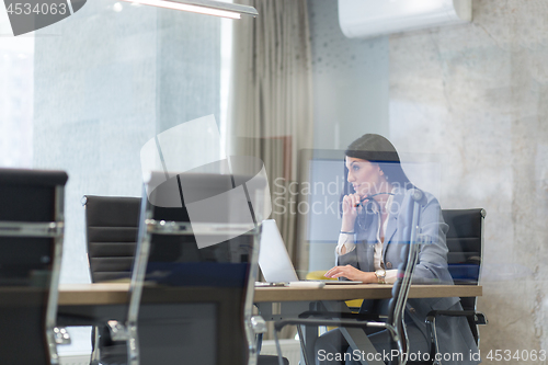 Image of businesswoman using a laptop in startup office