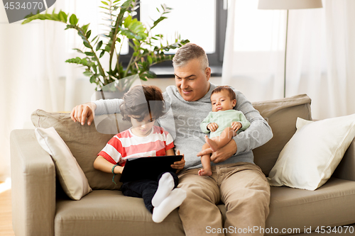 Image of happy father with preteen and baby son at home
