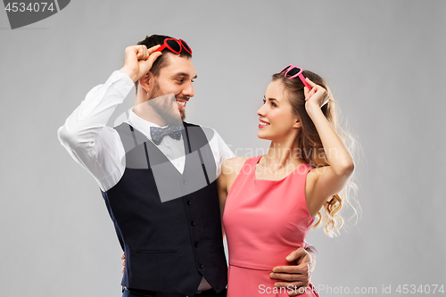 Image of happy couple in heart-shaped sunglasses
