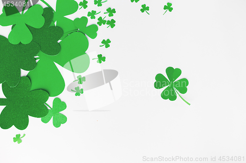 Image of green paper shamrocks on white background