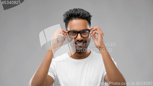 Image of happy indian man in eyeglasses or student