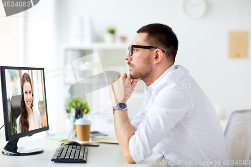 Image of businessman having video call on office computer