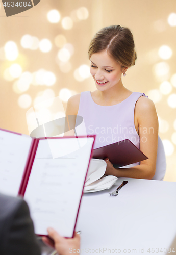 Image of couple with menus at restaurant