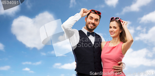 Image of happy couple in heart-shaped sunglasses