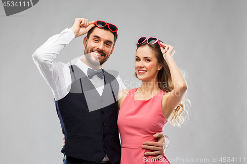 Image of happy couple in heart-shaped sunglasses