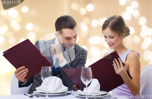 Image of couple with menus at restaurant