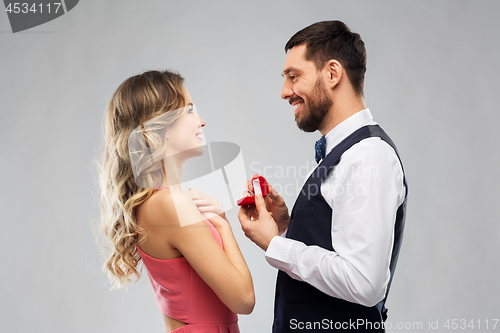 Image of man giving woman engagement ring on valentines day