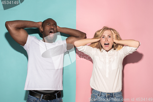 Image of We won. Winning success happy afro man and woman celebrating being a winner. Dynamic image of caucasian female and male model on pink studio.