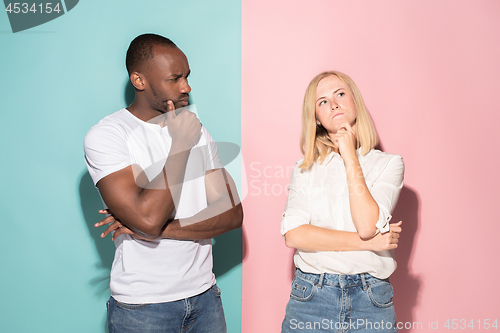 Image of Young serious thoughtful businessman and woman. Doubt concept.