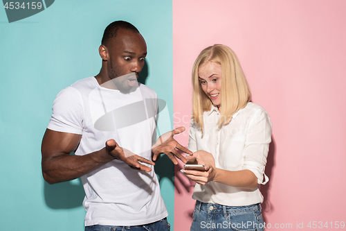 Image of Portrait of a confident casual girl with mobile phone and afro man