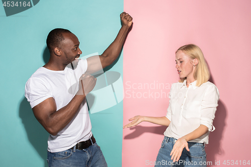 Image of We won. Winning success happy afro man and woman celebrating being a winner. Dynamic image of caucasian female and male model on pink studio.