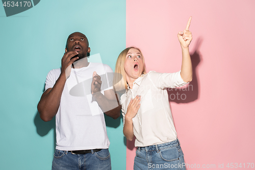 Image of Portrait of the scared man and woman on pink and blue