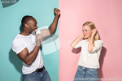 Image of We won. Winning success happy afro man and woman celebrating being a winner. Dynamic image of caucasian female and male model on pink studio.