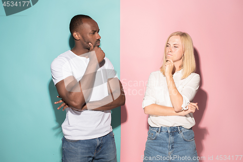 Image of Young serious thoughtful businessman and woman. Doubt concept.