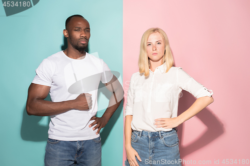 Image of Young serious thoughtful businessman and woman. Doubt concept.