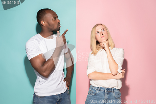 Image of Young serious thoughtful businessman and woman. Doubt concept.