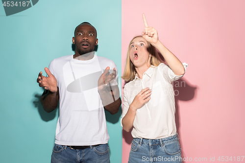 Image of Portrait of the scared man and woman on pink and blue