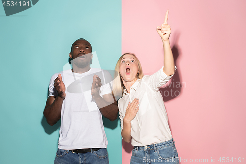 Image of Portrait of the scared man and woman on pink and blue