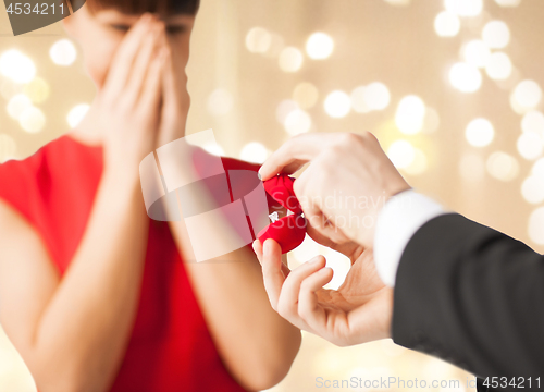Image of man giving diamond ring to woman on valentines day