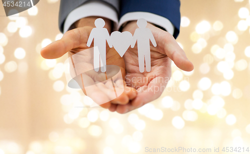 Image of close up of happy male gay couple with love symbol