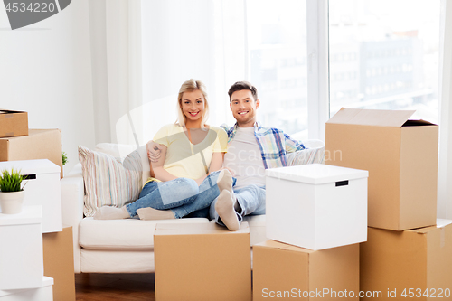 Image of happy couple with boxes moving to new home