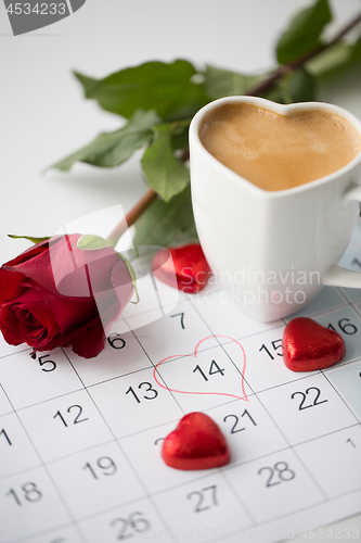 Image of close up of calendar, hearts, coffee and red rose