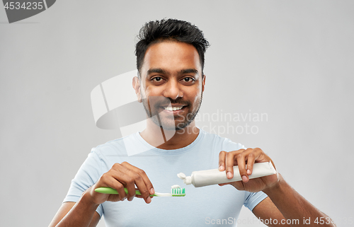 Image of indian man with toothbrush and toothpaste