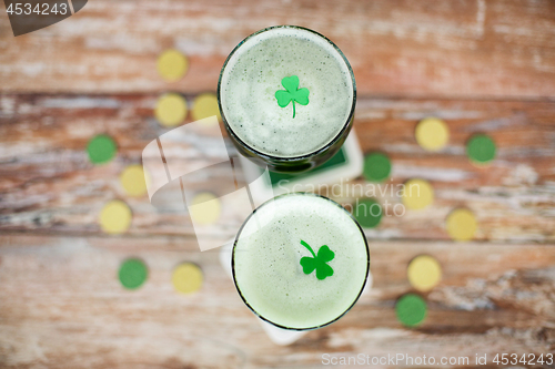 Image of glasses of green beer with shamrock from top