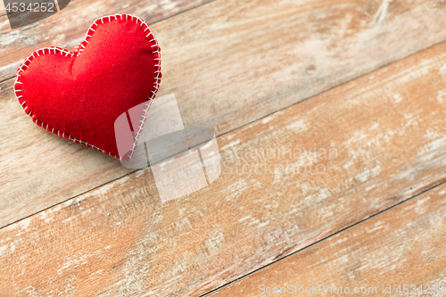 Image of red heart shaped decoration on wooden background