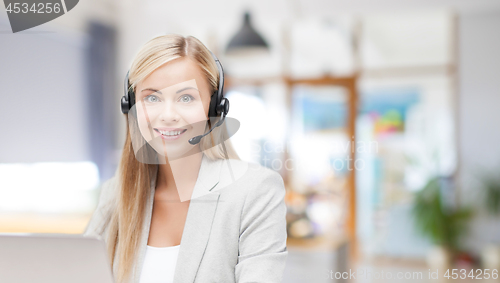 Image of helpline operator in headset working at office