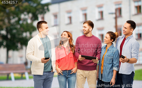 Image of students with smartphones and tablet computer