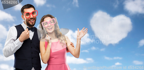 Image of couple with party props having fun and posing