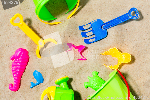 Image of close up of sand toys kit on summer beach