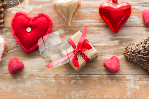Image of christmas gift and heart shaped decorations
