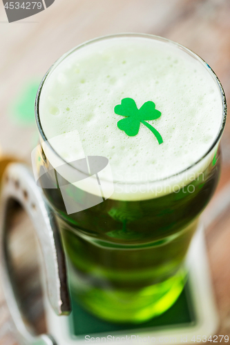 Image of close up of glass of green beer with shamrock