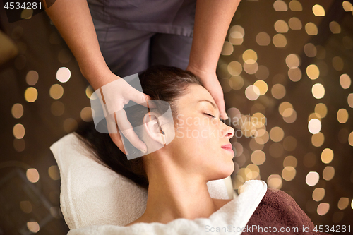 Image of woman having head massage at spa