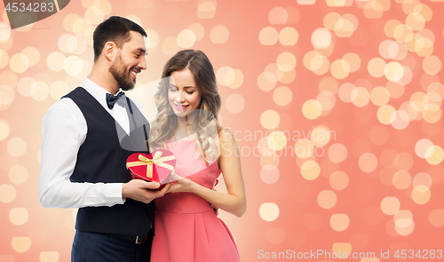 Image of happy couple with gift on valentines day