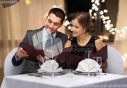 Image of couple with menus at restaurant