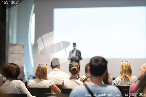 Image of Male business speaker giving a talk at business conference event.